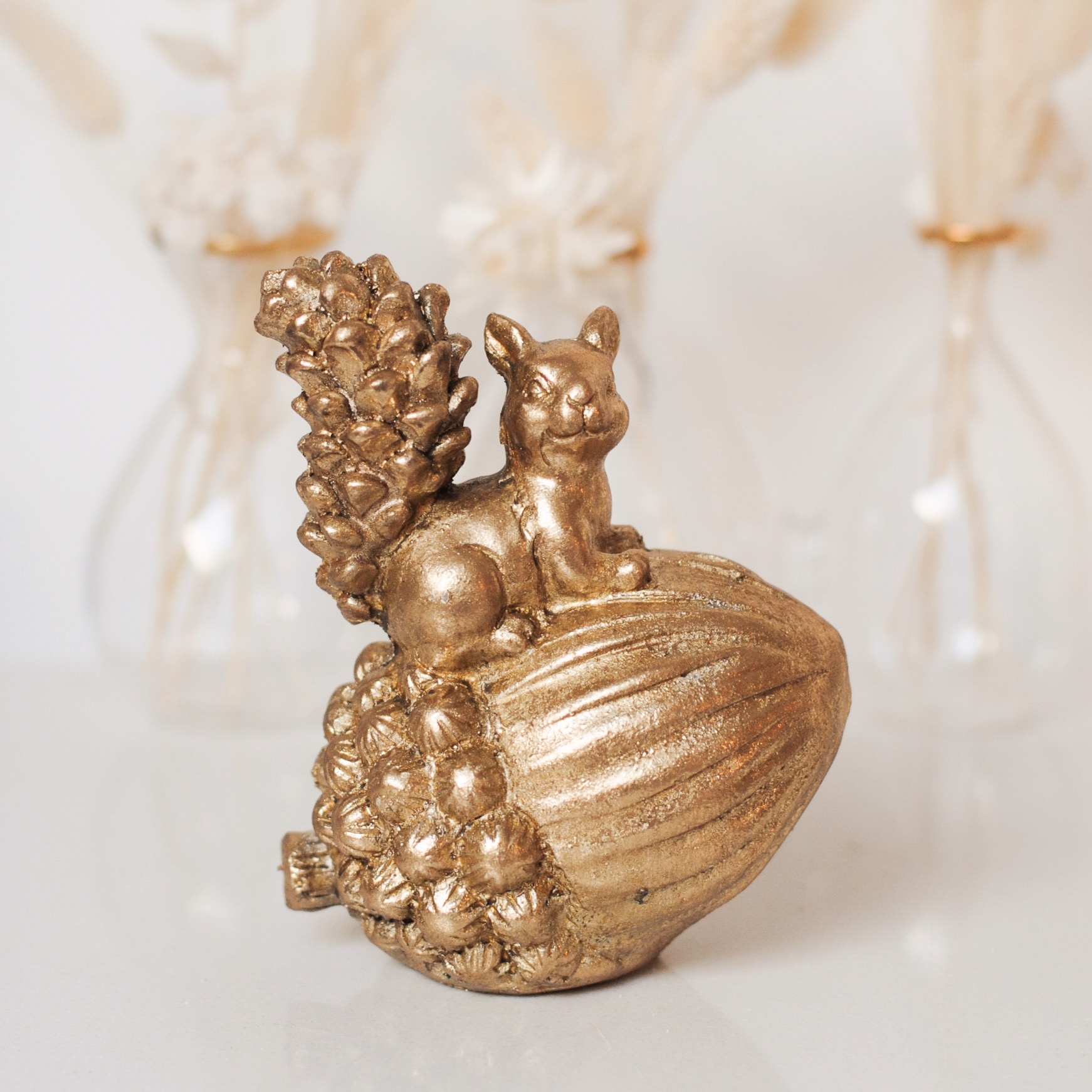 GOLD SQUIRREL ON ACORN