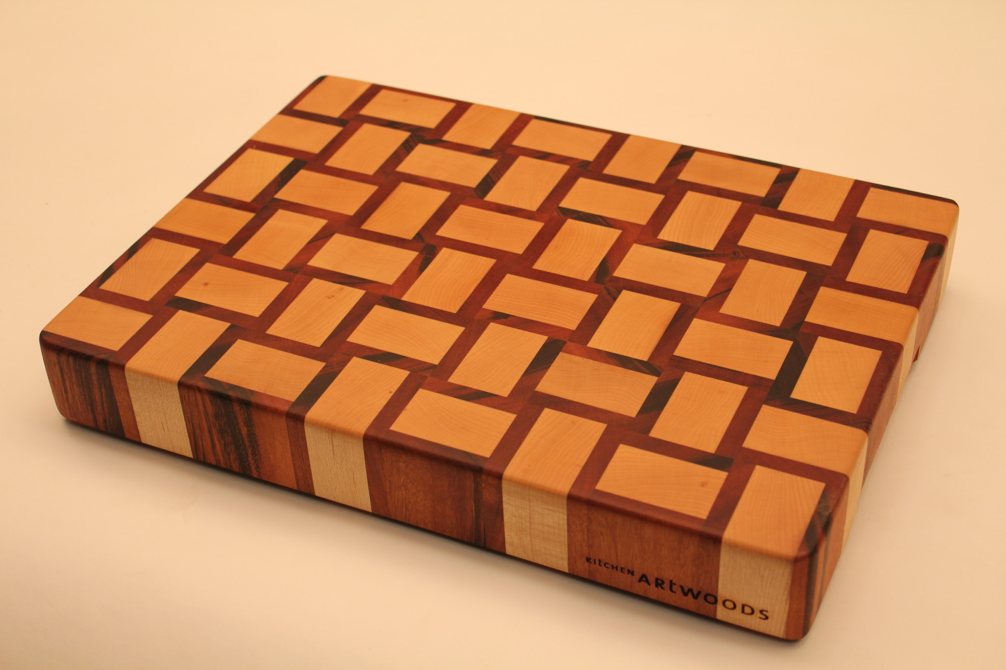 Kitchen Artwoods end grain cuttingboard with a woven patern of hard maple and tigerwood