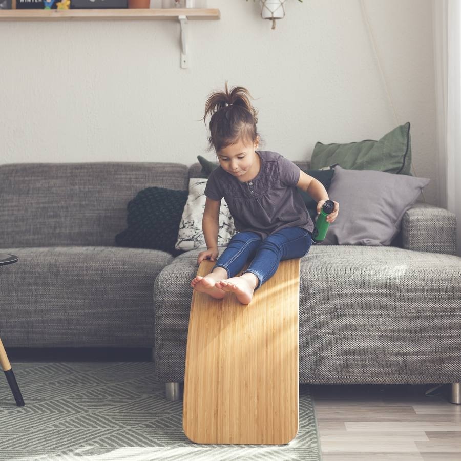 Two young children discovering the Wobbel balance board together