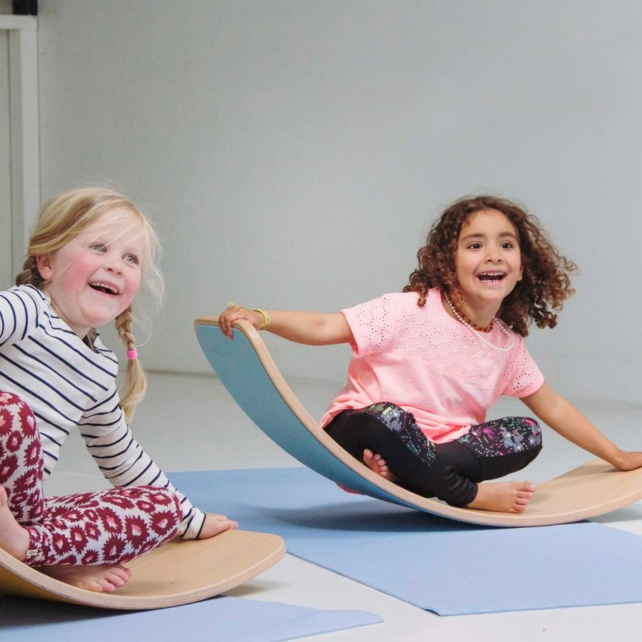 Two girls laughing on a Wobbel balance board