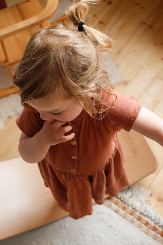 Young child standing on a Wobbel Starter balance board