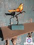 Metal bird on stand