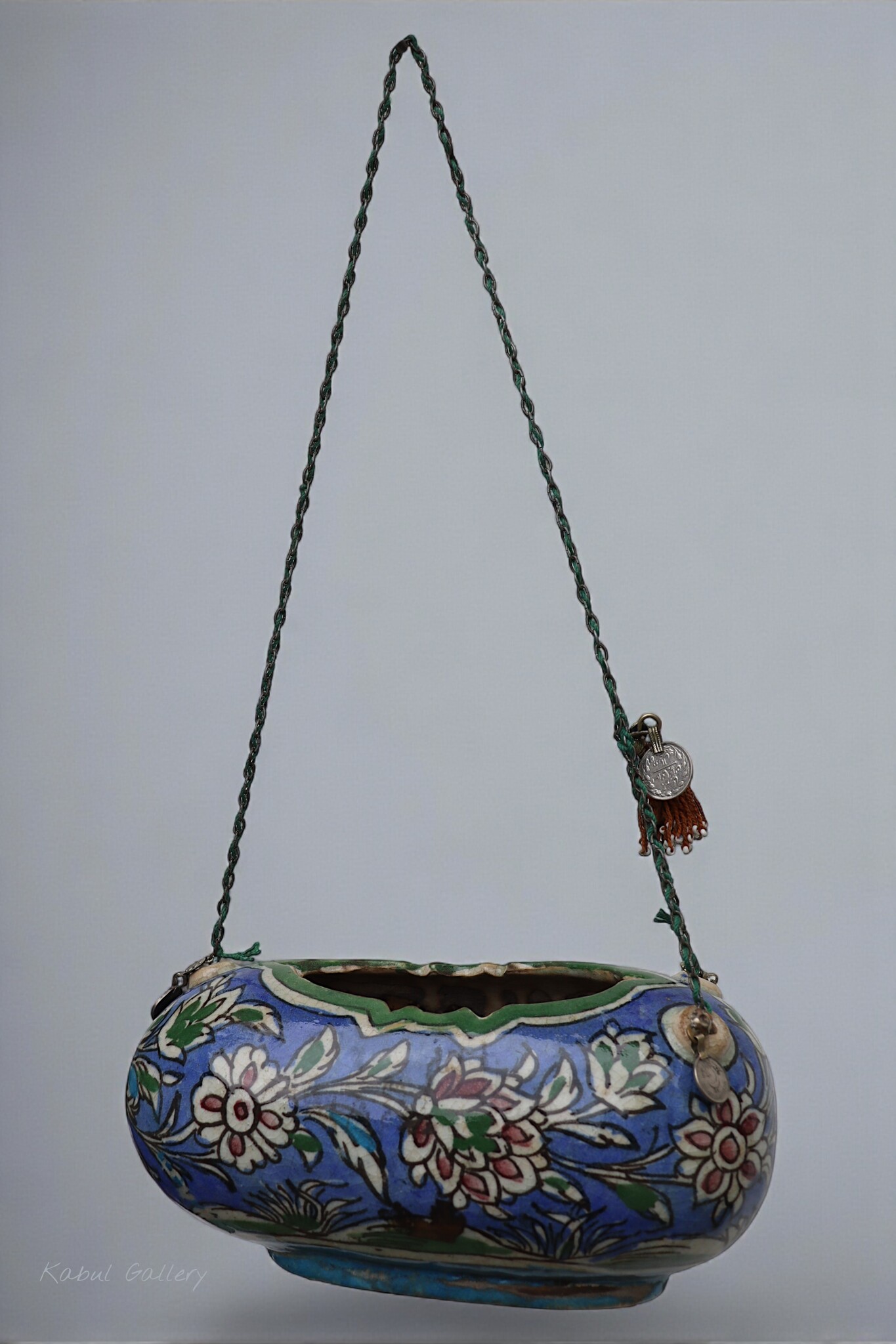 islamic Qajar Kashkul, 20th Century, made from ceramic, stone paste with polychrome flower decoration  underneath a clear glaze.   25A