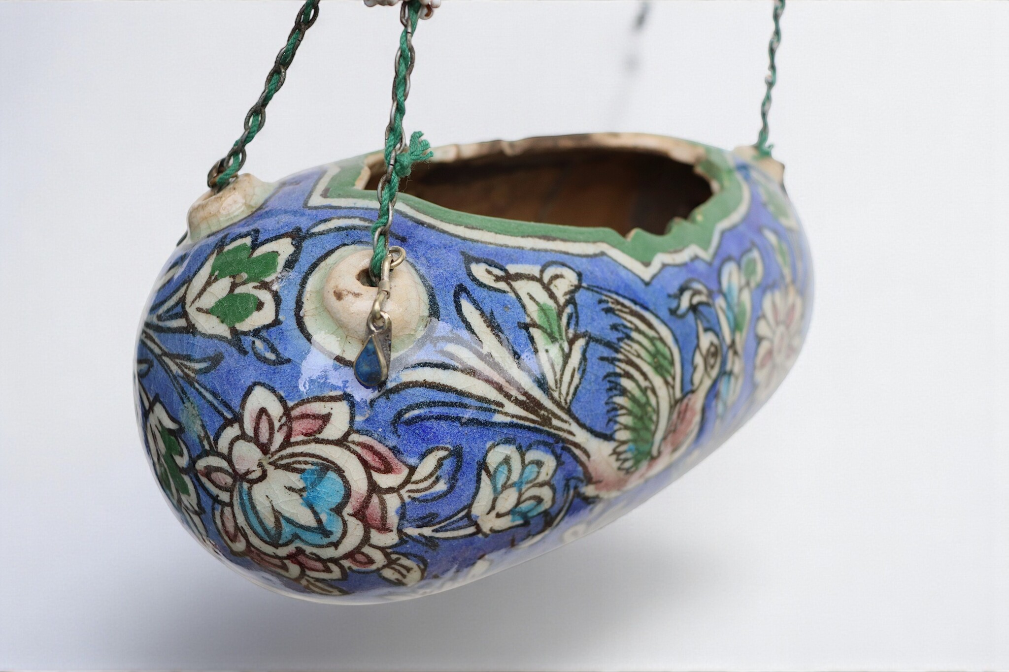 islamic Qajar Kashkul, 20th Century, made from ceramic, stone paste with polychrome flower decoration  underneath a clear glaze.   25A