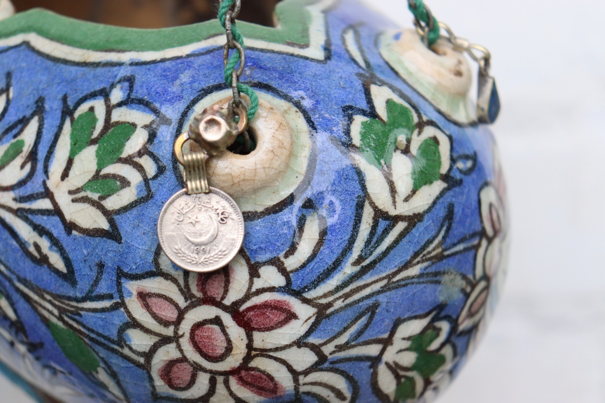 islamic Qajar Kashkul, 20th Century, made from ceramic, stone paste with polychrome flower decoration  underneath a clear glaze.   25A