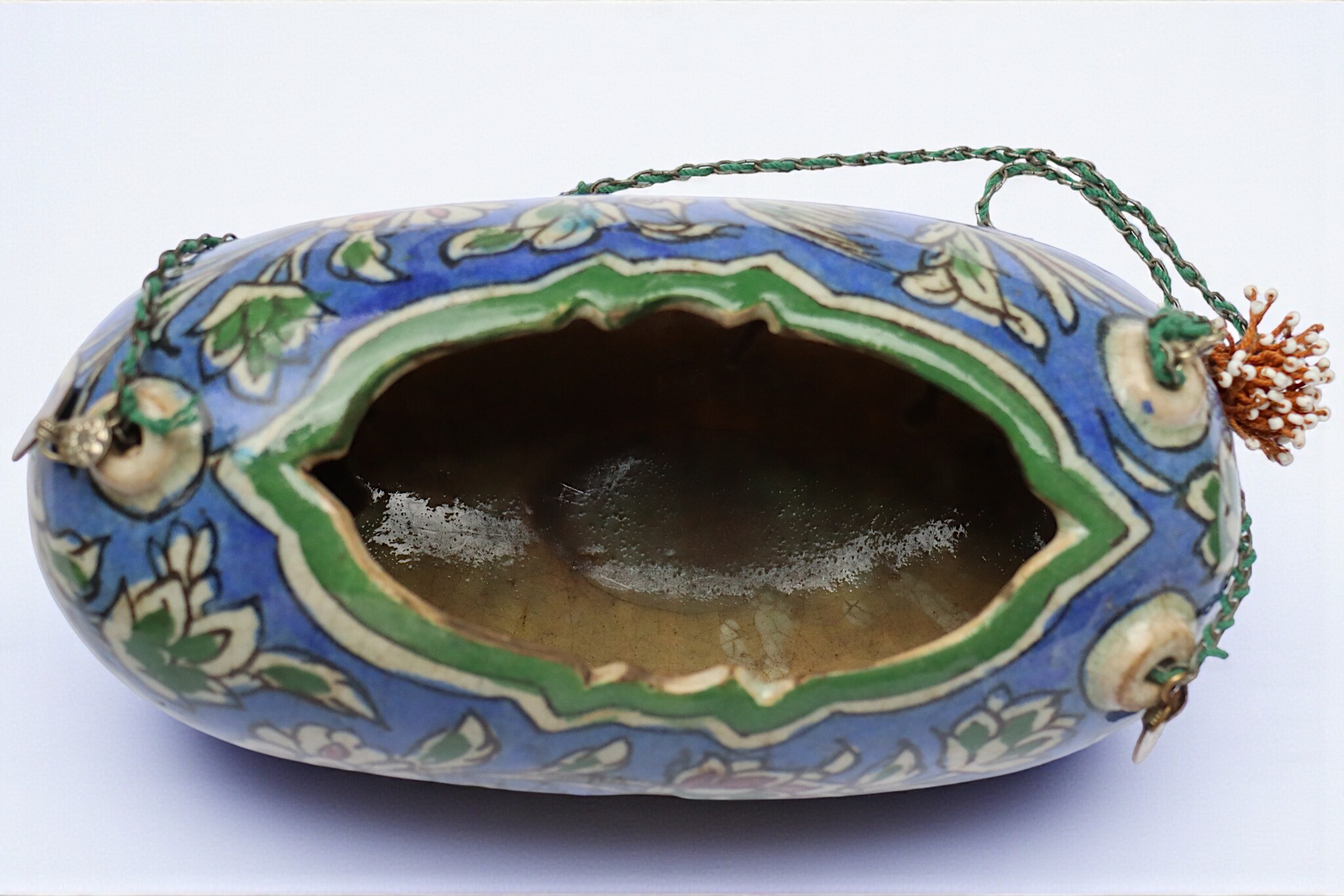 islamic Qajar Kashkul, 20th Century, made from ceramic, stone paste with polychrome flower decoration  underneath a clear glaze.   25A