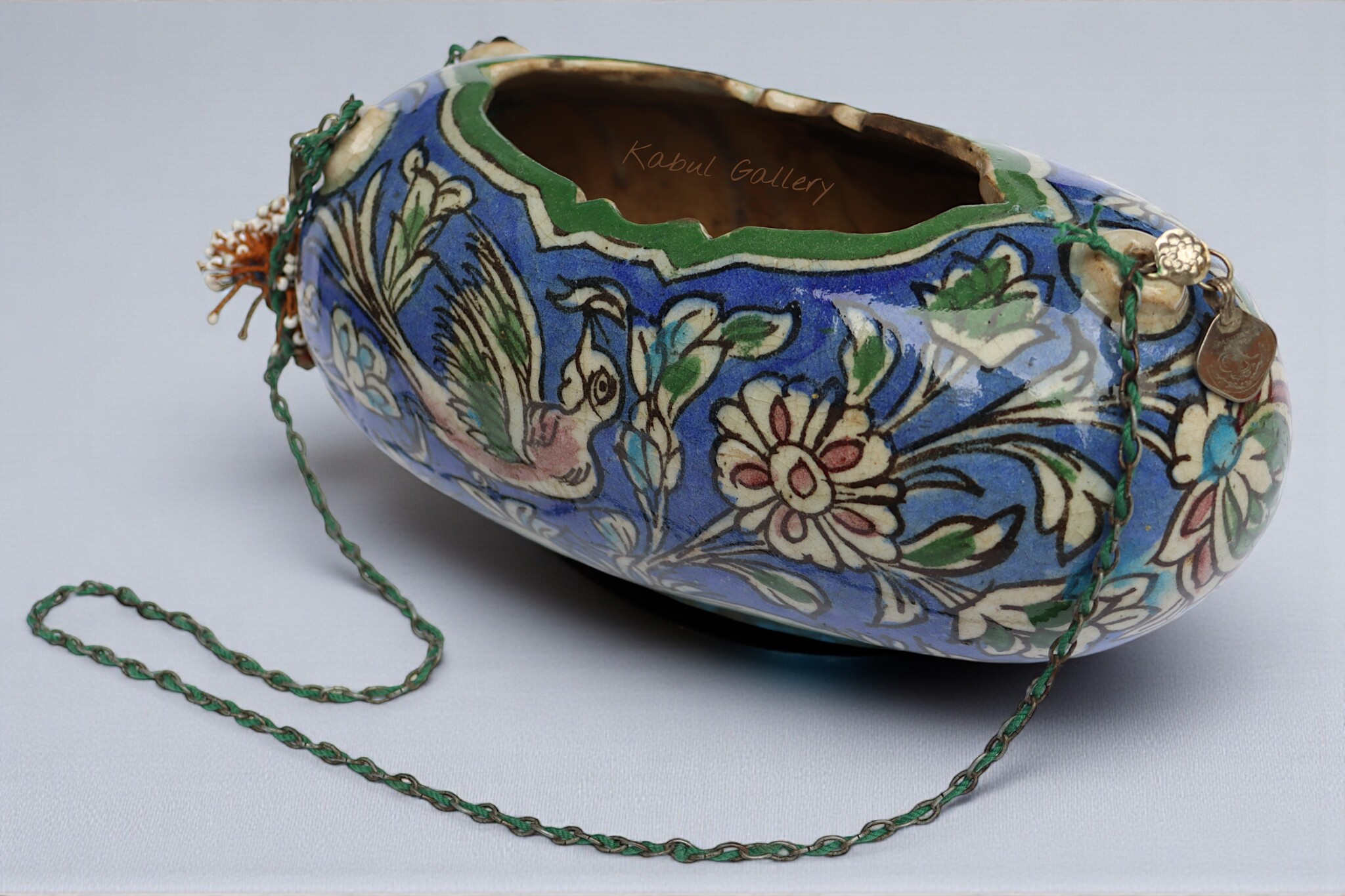 islamic Qajar Kashkul, 20th Century, made from ceramic, stone paste with polychrome flower decoration  underneath a clear glaze.   25A