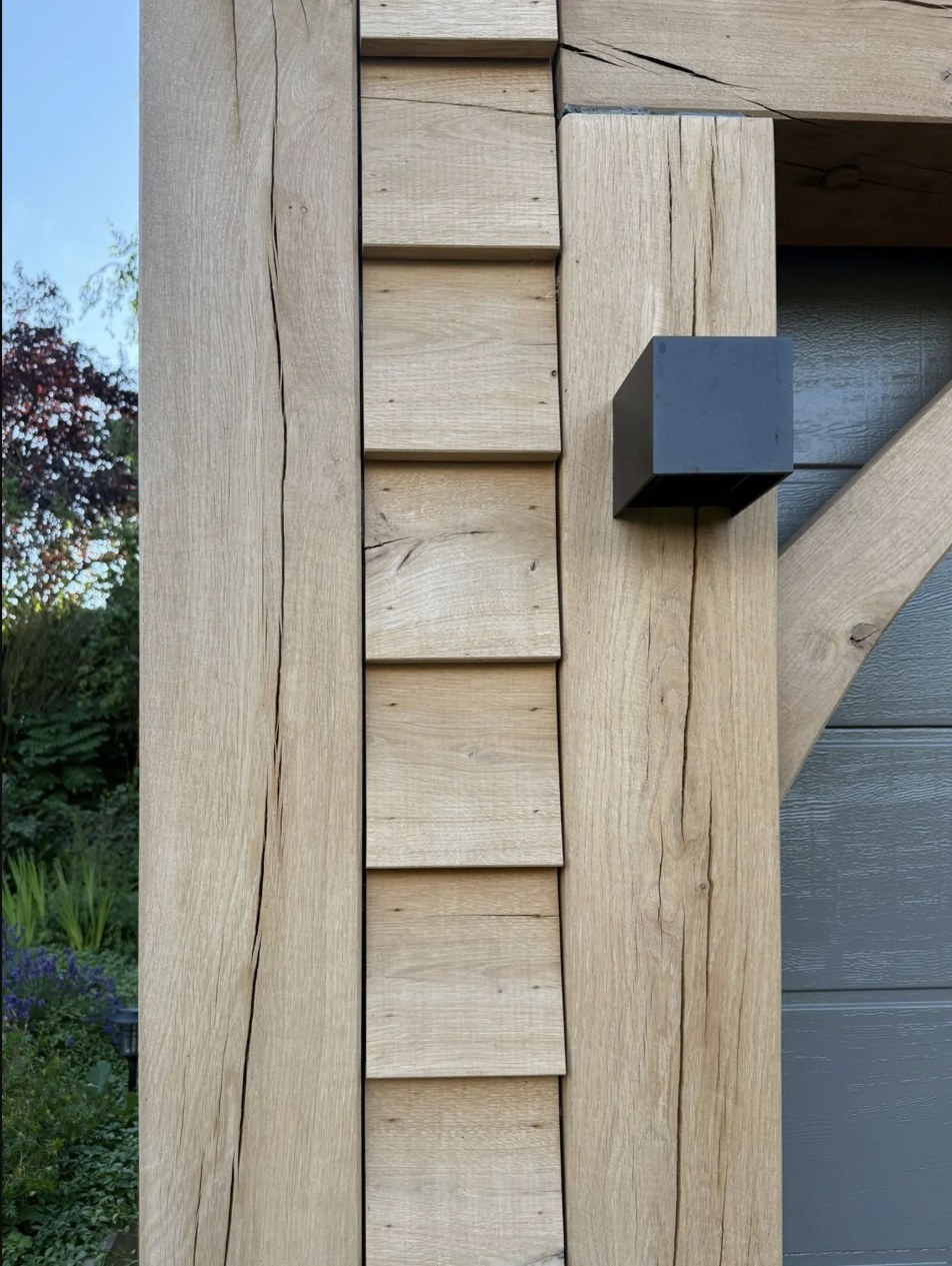 Detail einer Eichenfassade mit Rabatschalung und Eichenständer, grobe Maserung und Trocknungsrisse