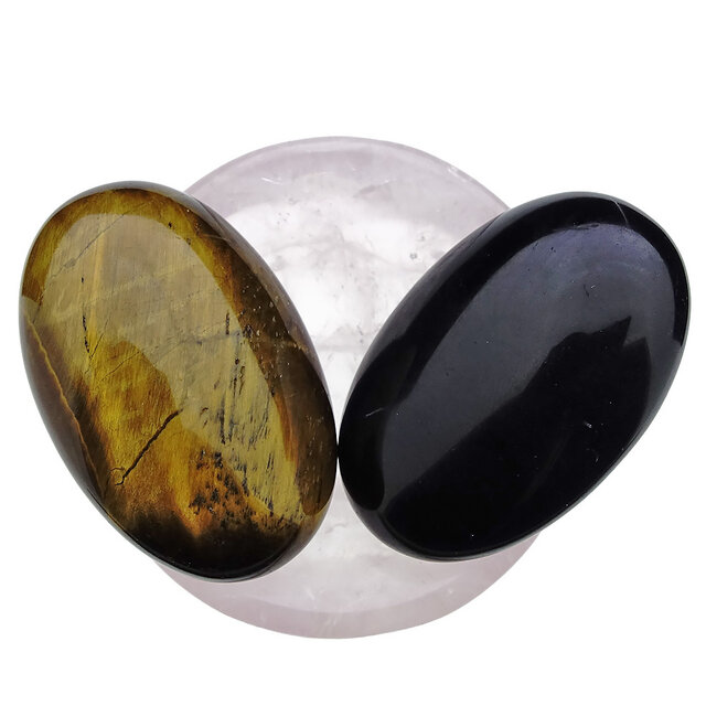 Bowl from rose quartz with handstones of tigereye and obsidian Bowl from rose quartz with handstones of tigereye and obsidian