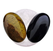 Bowl from rose quartz with handstones of tigereye and obsidian