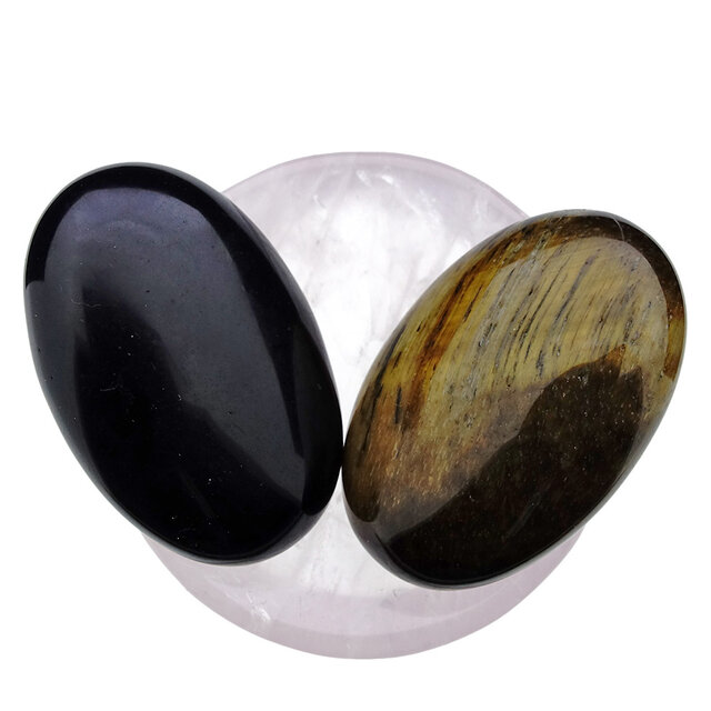 Bowl from rose quartz with handstones of tigereye and obsidian Bowl from rose quartz with handstones of tigereye and obsidian