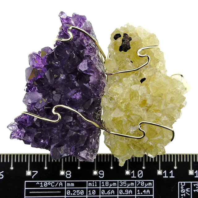 Pendant of rough heated and natural amethyst. The pendant is goldplated