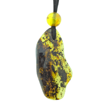 Beautiful pierced Baltic amber pendant with cord