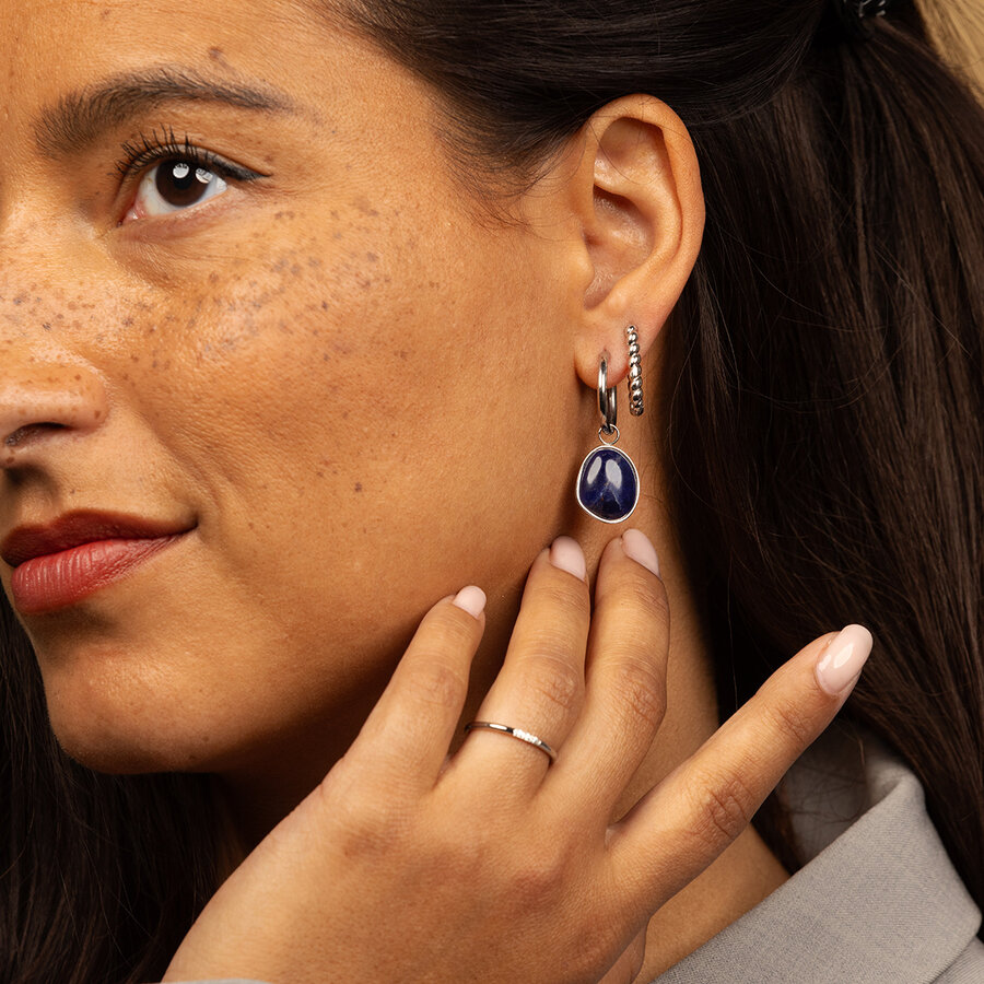 My Bendel Beautiful combination of a round silver-colored creole with a round Sodalite pendant