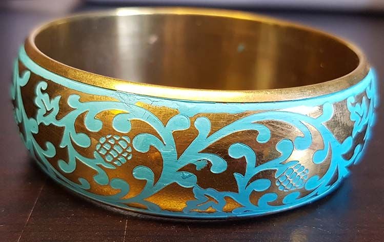 Gold bracelet with turquoise ornamental painting