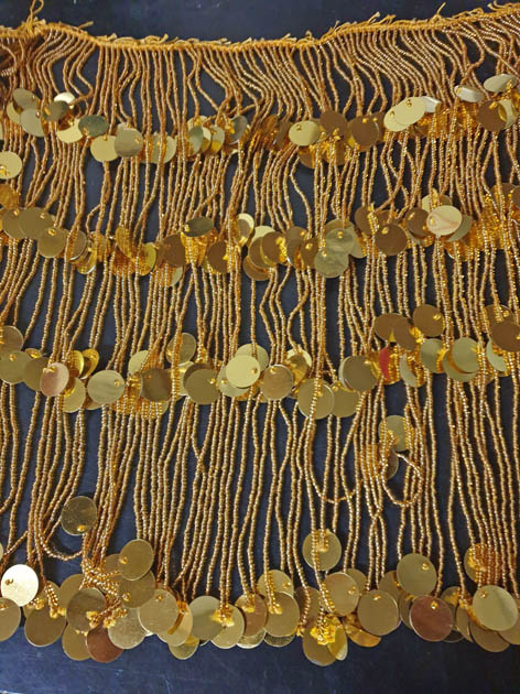 Beaded strip with gold or silver strands with many beads