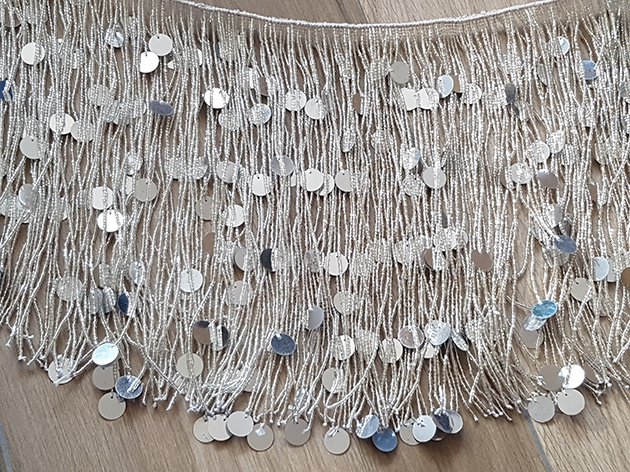 Beaded strip with gold or silver strands with many beads