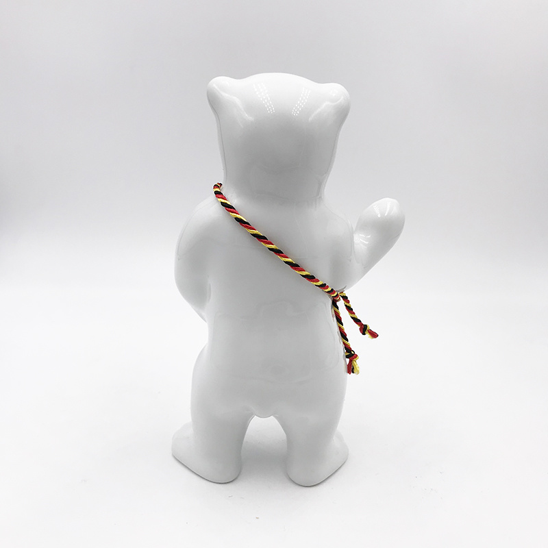 ART-DOMINO® BY SABINE WELZ Porcelain bear from Berlin - With black, red and yellow sash