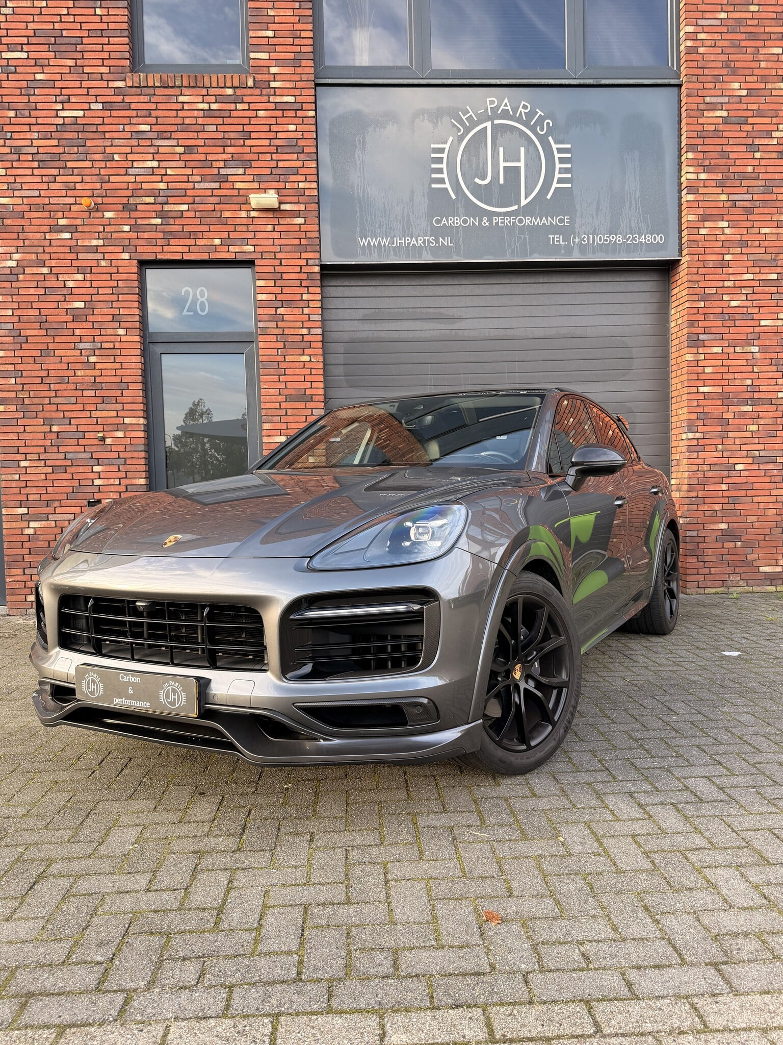 Grey Porsche Cayenne Coupé with a fitted TK front lip outside JHParts
