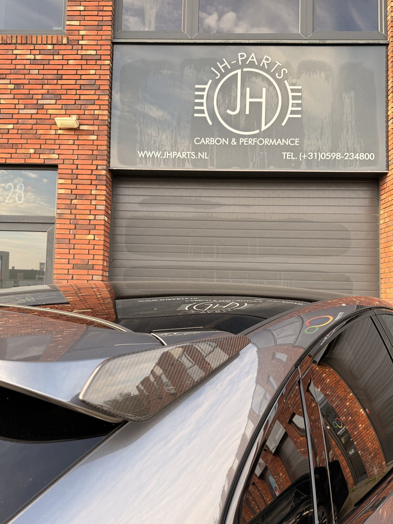Close-up of the Turbo GT-style carbon roof spoiler winglet on this Porsche Cayenne Coupé