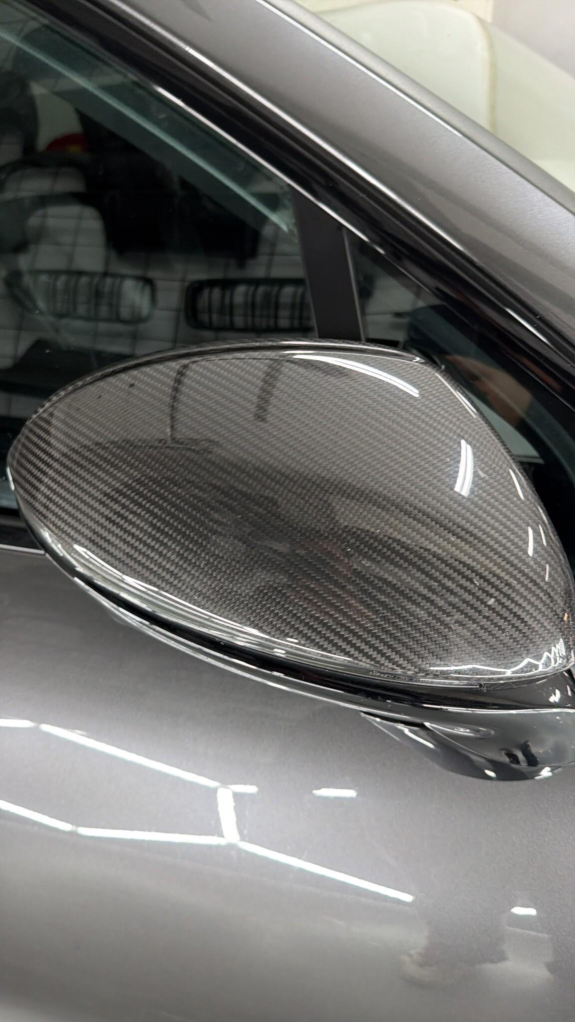 Close-up of a carbon mirror cap on the Porsche Cayenne Coupé