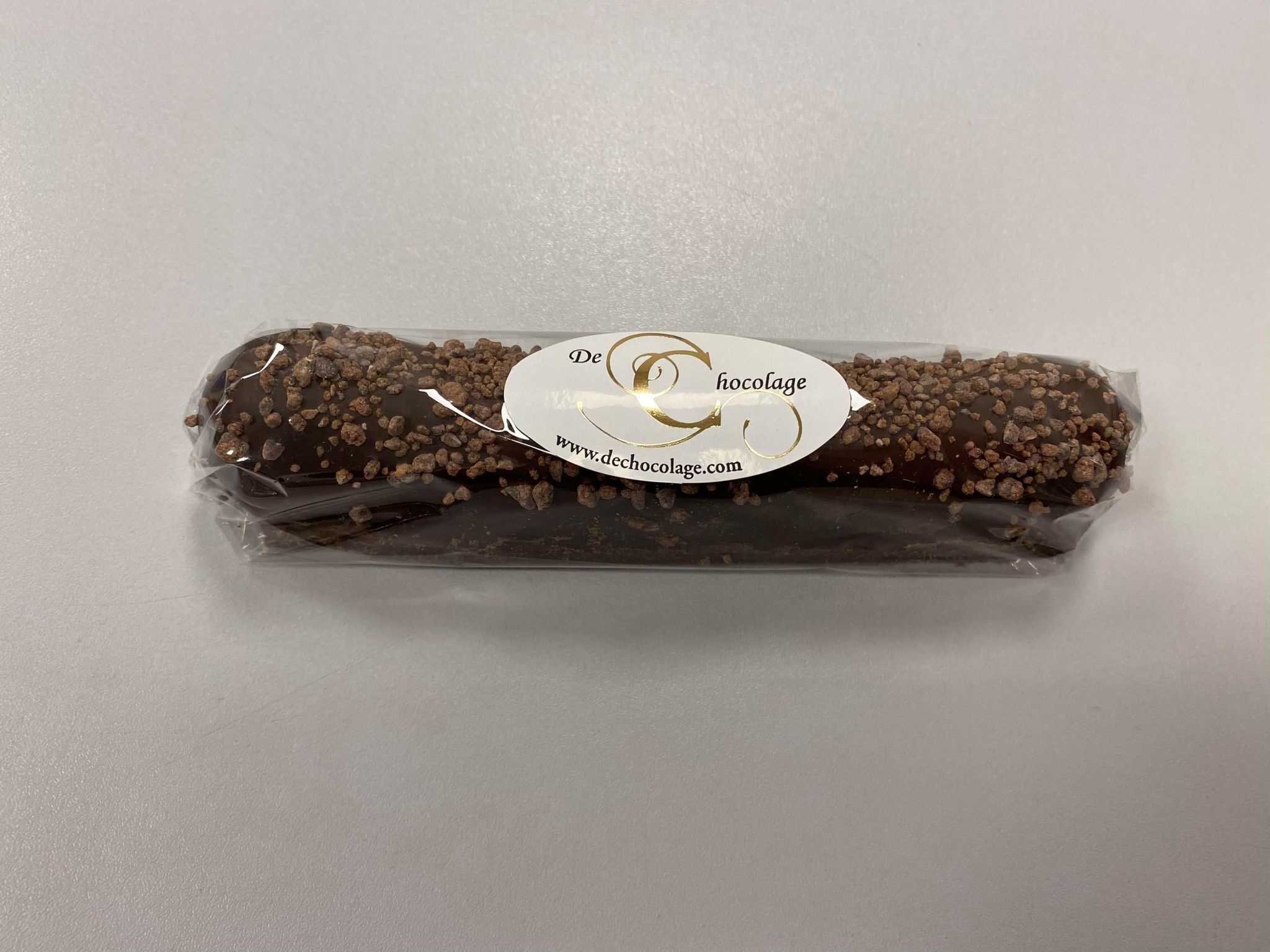 Date bar covered with dark chocolate & cocoa nibs