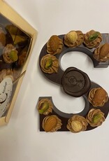 Dark chocolate letter with hazelnut tufts and nuts