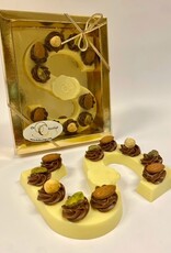 White chocolate letter with hazelnut tufts and nuts