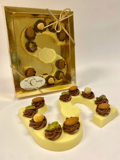 White chocolate letter with hazelnut tufts and nuts