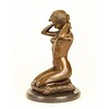 Bronze sculpture of a naked woman putting on her necklace