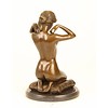 Bronze sculpture of a naked woman putting on her necklace