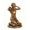 Bronze sculpture of a naked woman putting on her necklace