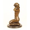 Bronze sculpture of a naked woman putting on her necklace