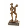 Bronze sculpture of a gay couple standing back to back