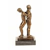 Bronze sculpture of a gay couple standing back to back