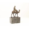 Bronze sculpture of a camel with it's rider