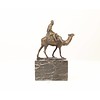 Bronze sculpture of a camel with it's rider