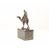 Bronze sculpture of a camel with it's rider