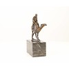 Bronze sculpture of a camel with it's rider