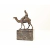 Bronze sculpture of a camel with it's rider