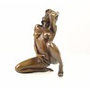 Bronze sculpture of a kneeling female nude pleasing herself