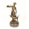 A bronze sculpture of a huntsman with horn and hounds