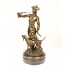 A bronze sculpture of a huntsman with horn and hounds