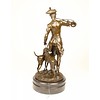 A bronze sculpture of a huntsman with horn and hounds