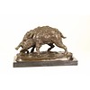 A bronze sculpture of a wild boar