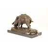 A bronze sculpture of a wild boar