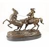 A bronze sculpture of a Kyrghiz capturing a wild horse