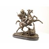 A bronze sculpture of an Arab horseman killing a lion