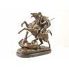 A bronze sculpture of an Arab horseman killing a lion