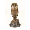 A bronze sculpture of a young owl